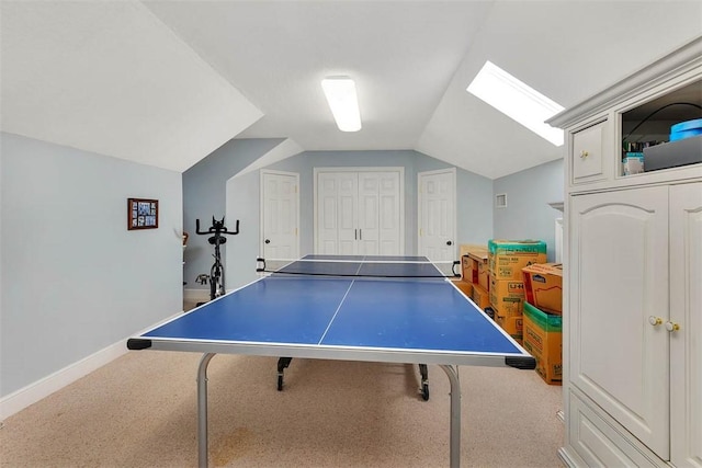 recreation room with vaulted ceiling and light colored carpet