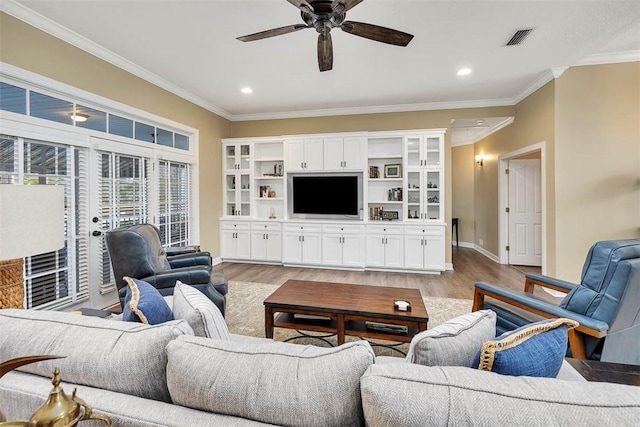 living room featuring crown molding, light wood-type flooring, and ceiling fan