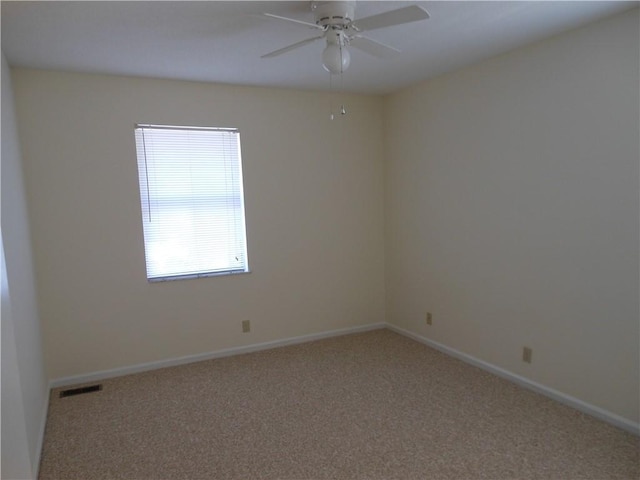 unfurnished room featuring ceiling fan and carpet floors