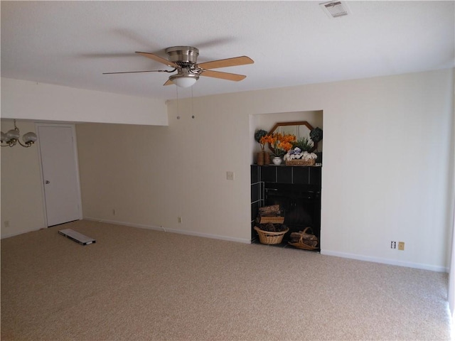 carpeted empty room with ceiling fan with notable chandelier