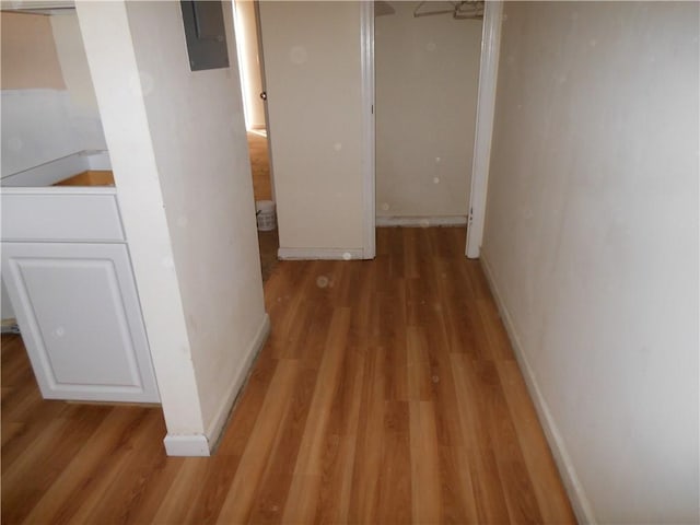 hallway with hardwood / wood-style floors and electric panel