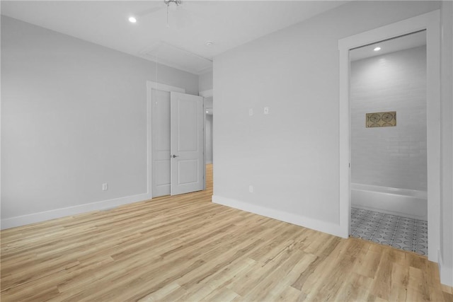231 Salt Creek Way E, Brunswick, GA 31523 - unfurnished bedroom with attic access, wood finished floors, ensuite bath, baseboards, and recessed lighting