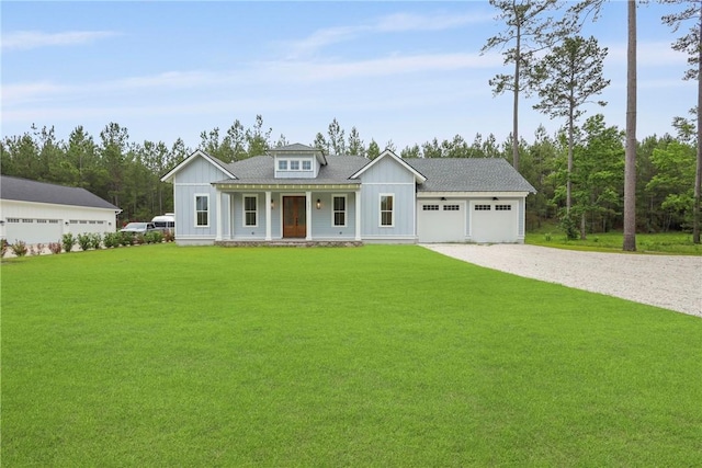 231 Salt Creek Way E, Brunswick, GA 31523 - modern farmhouse style home featuring covered porch, driveway, board and batten siding, and a garage