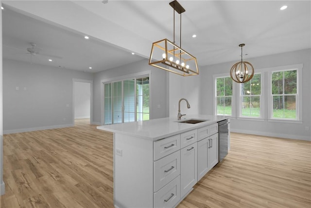 231 Salt Creek Way E, Brunswick, GA 31523 - kitchen featuring a sink, stainless steel dishwasher, a chandelier, light wood-style floors, and baseboards