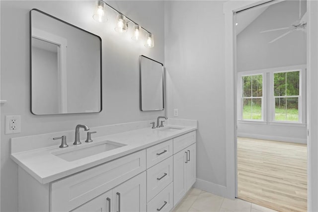 231 Salt Creek Way E, Brunswick, GA 31523 - bathroom featuring double vanity, baseboards, a ceiling fan, and vaulted ceiling