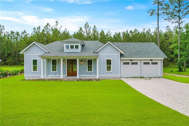 231 Salt Creek Way E, Brunswick, GA 31523 - modern farmhouse with board and batten siding, a porch, gravel driveway, a garage, and a front lawn