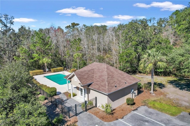 birds eye view of property with a wooded view