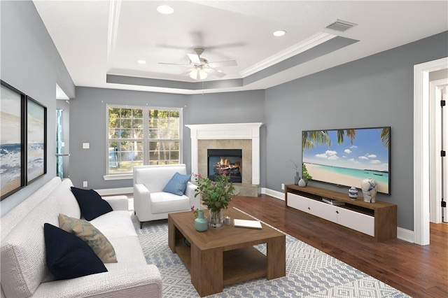 22 Millpond Cir, Brunswick, GA 31525 - living room with ceiling fan, wood finished floors, a tile fireplace, a tray ceiling, and recessed lighting