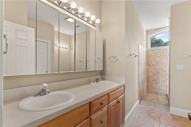 bathroom with tile patterned flooring, a shower, and vanity