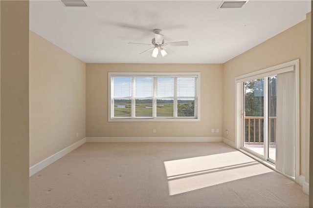 carpeted empty room featuring ceiling fan