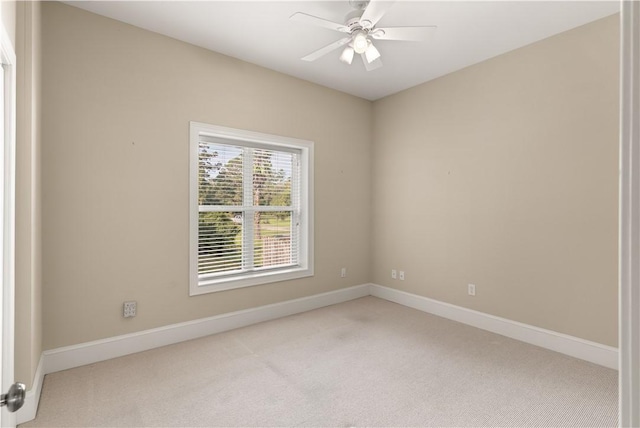 carpeted spare room featuring ceiling fan