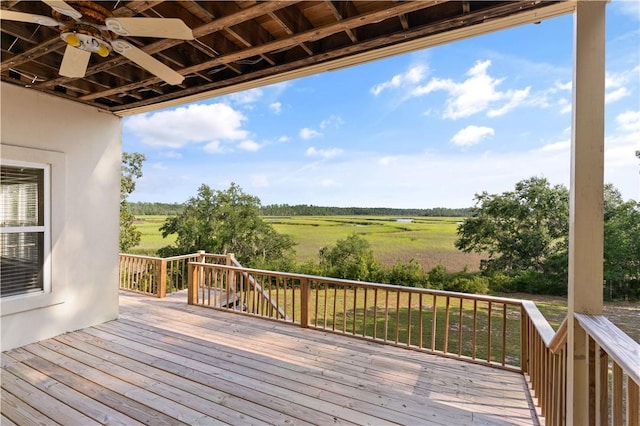 wooden terrace featuring ceiling fan and a rural view