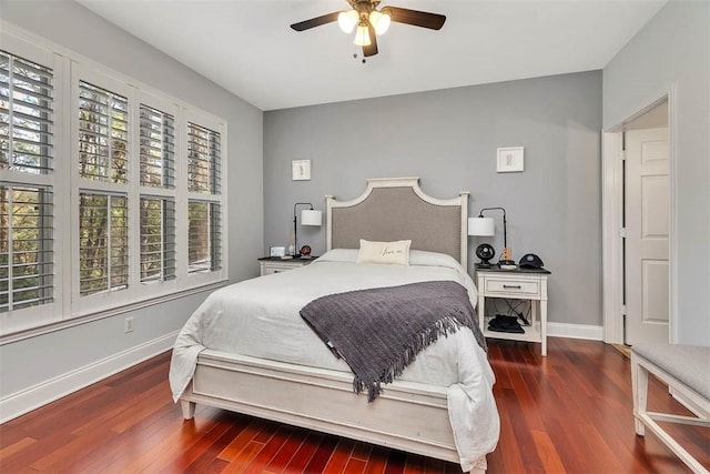 bedroom featuring dark wood-style floors, ceiling fan, and baseboards