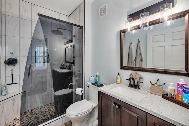 full bath with visible vents, toilet, baseboard heating, vanity, and a shower stall