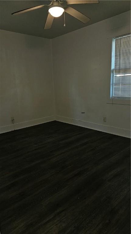 spare room featuring dark hardwood / wood-style floors and ceiling fan