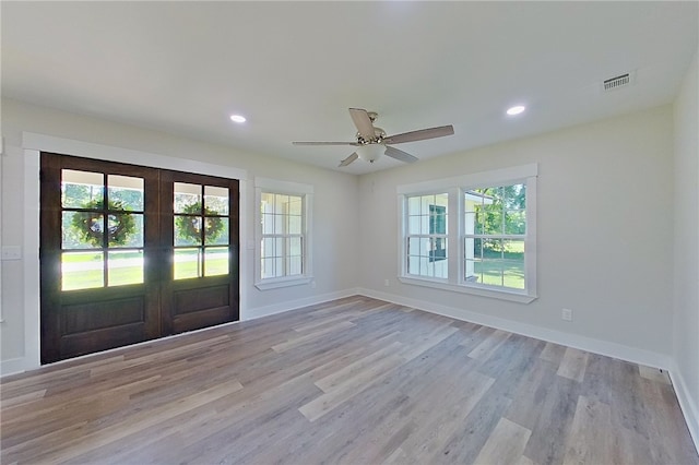880 Miles Still Rd, Waycross, GA 31503 - empty room with french doors, healthy amount of natural light, light wood finished floors, baseboards, and recessed lighting