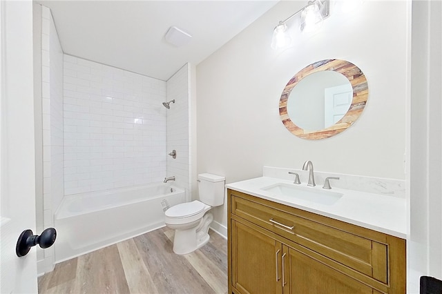 880 Miles Still Rd, Waycross, GA 31503 - full bathroom featuring wood finished floors, toilet, vanity, washtub / shower combination, and baseboards