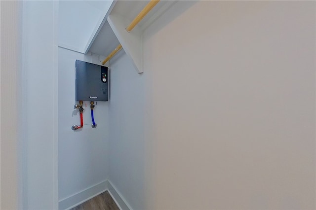880 Miles Still Rd, Waycross, GA 31503 - laundry area with baseboards, dark wood finished floors, and water heater