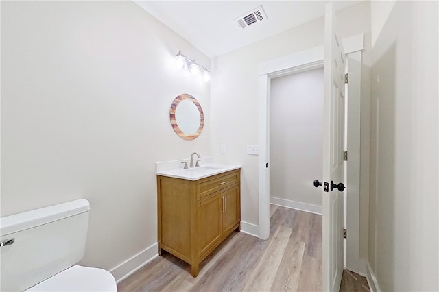 880 Miles Still Rd, Waycross, GA 31503 - bathroom with vanity, wood finished floors, toilet, and baseboards