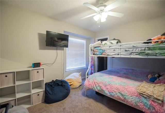 bedroom with carpet, a textured ceiling, and ceiling fan