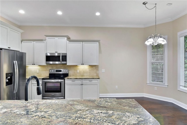 kitchen featuring light stone countertops, white cabinets, and appliances with stainless steel finishes