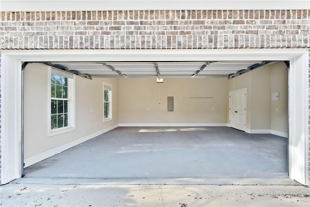 garage with a garage door opener and electric panel