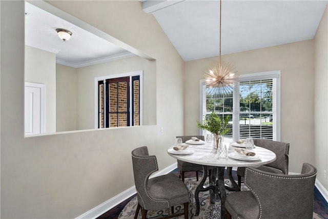 dining room with ornamental molding, dark hardwood / wood-style floors, a chandelier, and vaulted ceiling