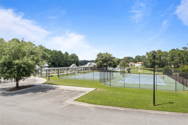 view of sport court with a lawn