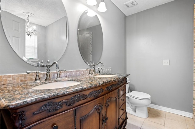 bathroom featuring vanity, tile patterned floors, toilet, a textured ceiling, and a notable chandelier