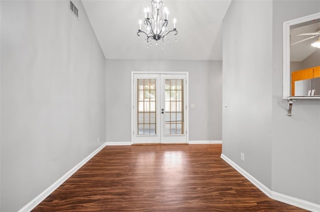 interior space featuring french doors, ceiling fan with notable chandelier, vaulted ceiling, and hardwood / wood-style floors