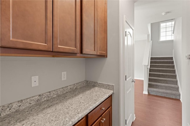 107 Heatherly Way, Brunswick, GA 31523 - kitchen featuring wood finished floors, brown cabinetry, and light stone counters