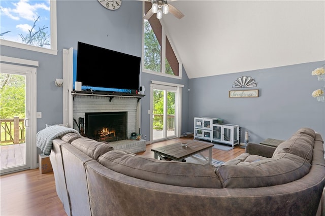 4936 US Highway 17 N, Brunswick, GA 31525 - living area with high vaulted ceiling, a brick fireplace, healthy amount of natural light, a ceiling fan, and wood finished floors