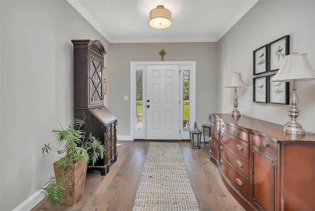 foyer entrance featuring baseboards, dark wood-style flooring, and crown molding