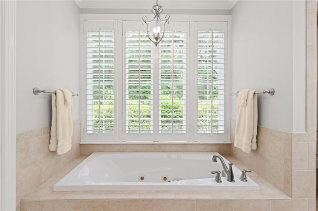 full bathroom featuring healthy amount of natural light, a jetted tub, and ornamental molding
