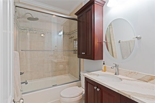 full bath featuring crown molding, bath / shower combo with glass door, vanity, and toilet