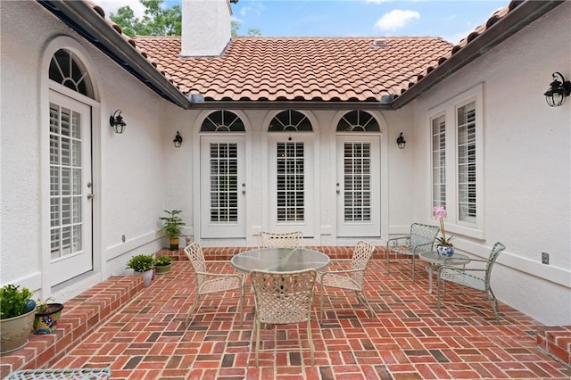 view of patio with french doors and outdoor dining space