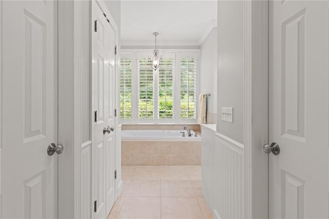 bathroom featuring a garden tub, tile patterned flooring, and ornamental molding