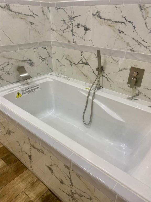 4726 New Jesup Hwy, Brunswick, GA 31520 - bathroom with a relaxing tiled tub and wood finished floors