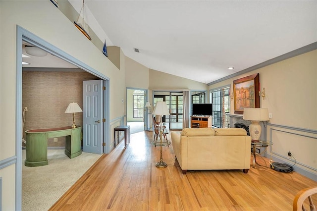 40 W Lake Dr, Saint Simons Island, GA 31522 - living room with lofted ceiling, a fireplace, and wood finished floors