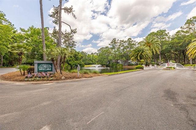 40 W Lake Dr, Saint Simons Island, GA 31522 - view of asphalt street with curbs, view of wooded area, and a water view