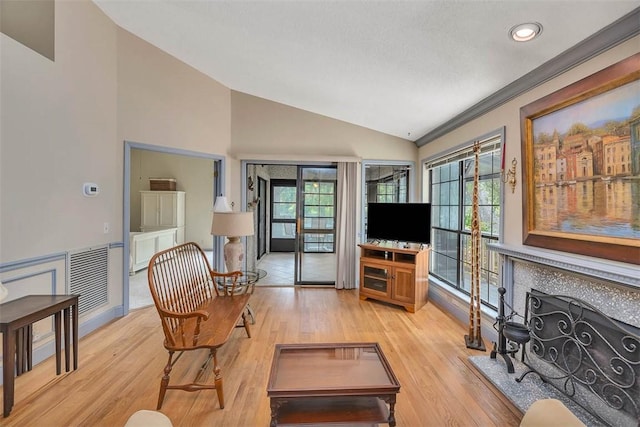 40 W Lake Dr, Saint Simons Island, GA 31522 - living area featuring vaulted ceiling, light wood finished floors, recessed lighting, and a fireplace