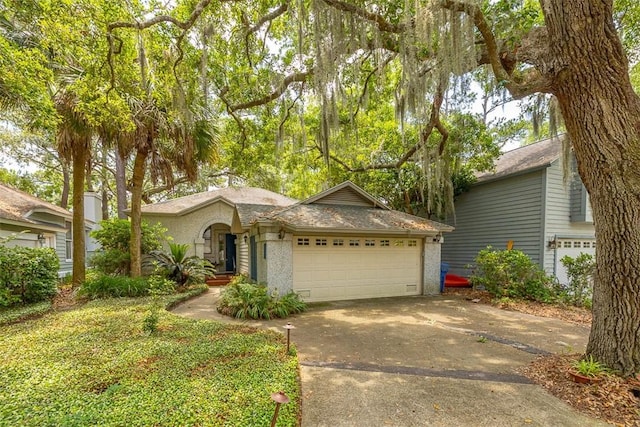 40 W Lake Dr, Saint Simons Island, GA 31522 - view of front facade with a garage and concrete driveway