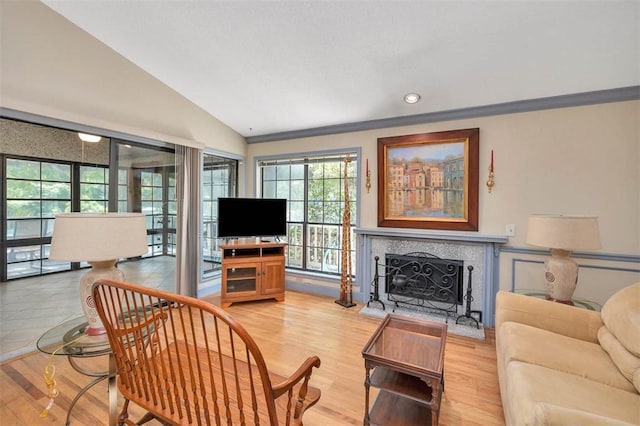 40 W Lake Dr, Saint Simons Island, GA 31522 - living room featuring vaulted ceiling, a tile fireplace, light wood finished floors, and recessed lighting