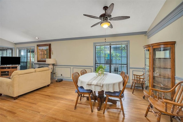 40 W Lake Dr, Saint Simons Island, GA 31522 - dining room with lofted ceiling, light wood finished floors, wainscoting, a decorative wall, and ceiling fan