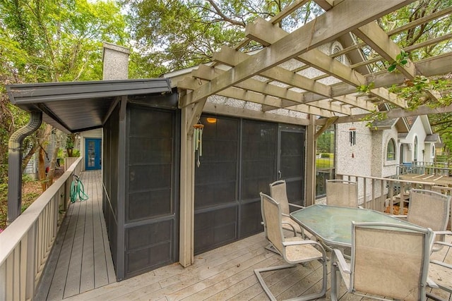 40 W Lake Dr, Saint Simons Island, GA 31522 - wooden deck featuring a pergola and outdoor dining space