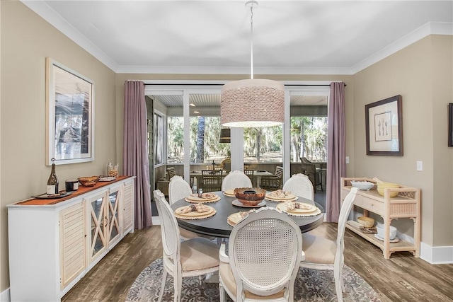 dining room with crown molding and dark hardwood / wood-style floors