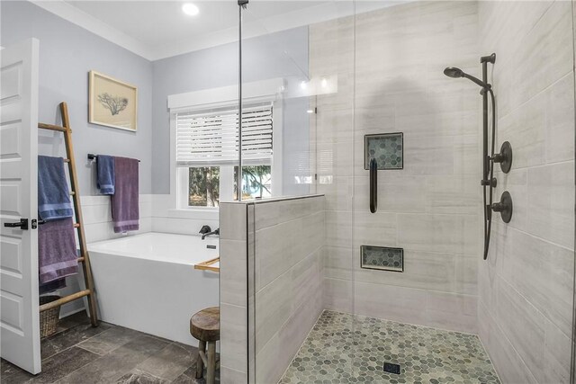 bathroom with crown molding and separate shower and tub