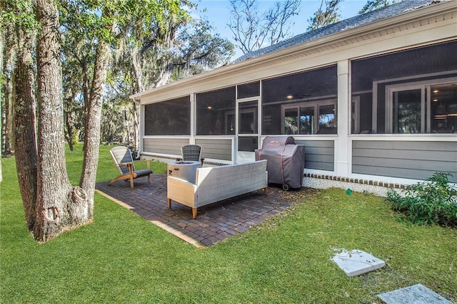 view of patio / terrace with grilling area, outdoor lounge area, and a sunroom