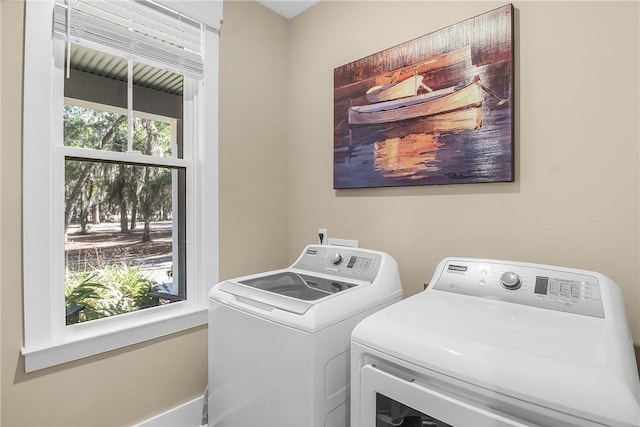 clothes washing area with washer and clothes dryer