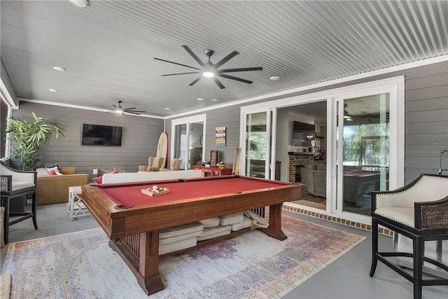 playroom featuring a fireplace, plenty of natural light, billiards, and wooden walls